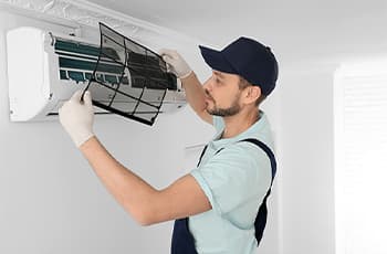 Male-technician-cleaning-air-conditioner-indoors---350X230