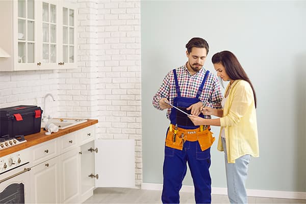 https://tower.top10homewarrantyranking.com/wp-content/uploads/2022/08/Img-for-post-Male-plumber-or-mechanic-talk-speak-with-female-client-at-home..jpg